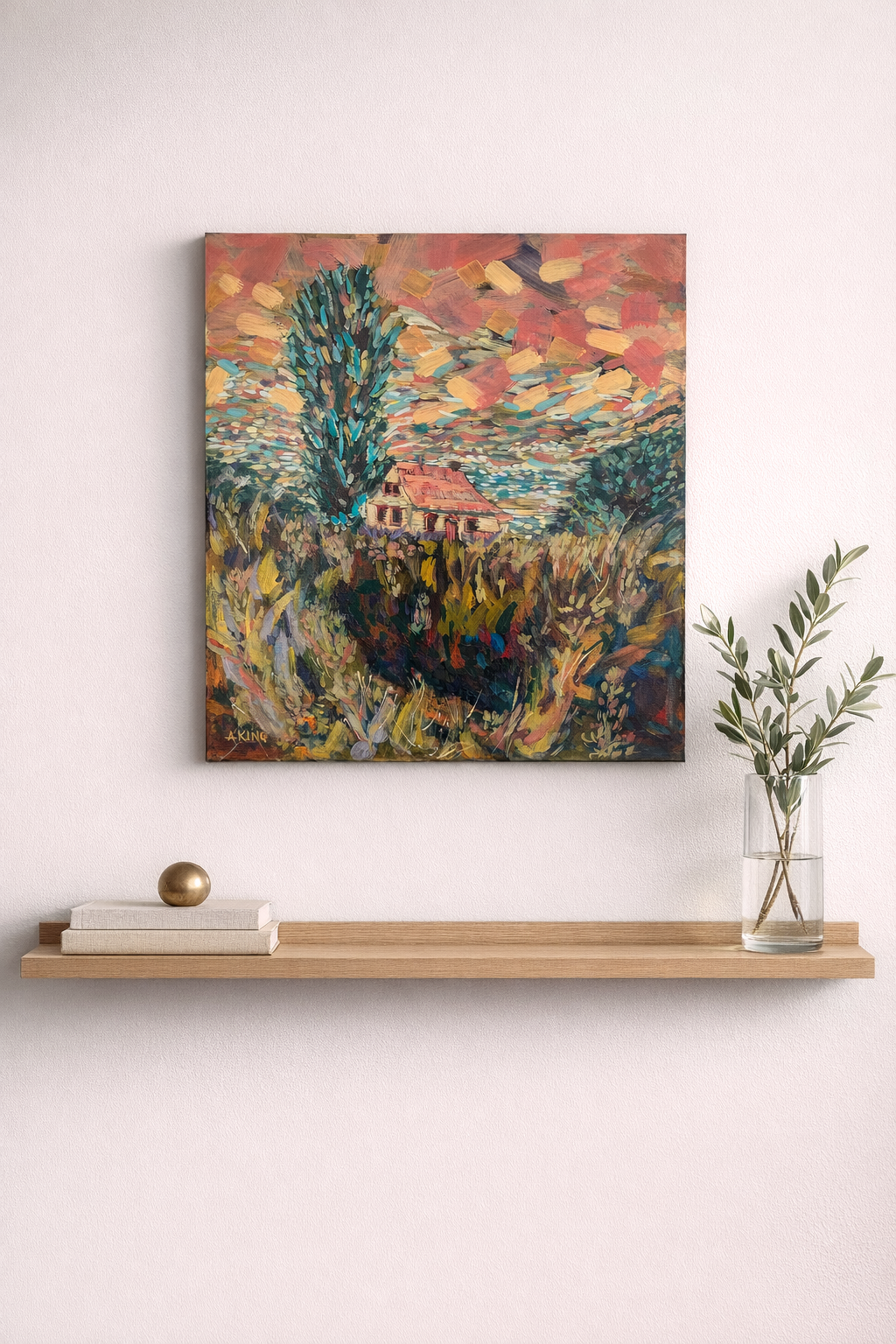 Abstract painting on a wall above a wooden shelf with books and a vase.