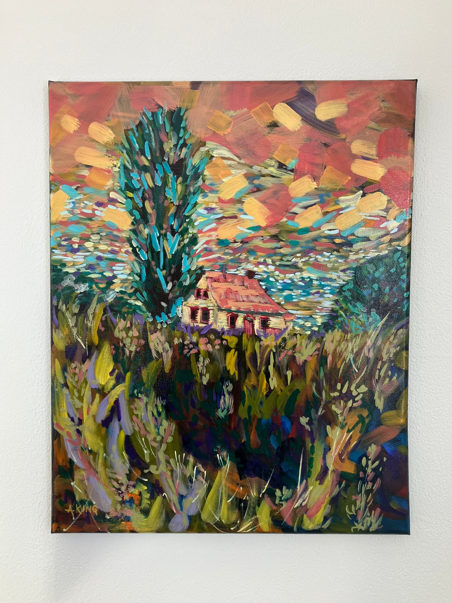 Colorful abstract painting of a house in a field on a white wall