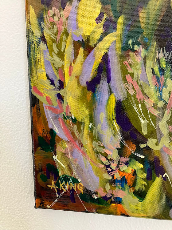 Abstract painting with vibrant colors on a white wall