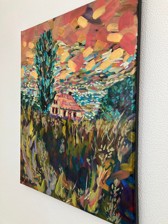 Colorful abstract painting of a house in a field on a white wall